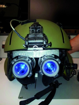 Fig. 5: Conventional image intensifier goggles; (a) mounted on the flight helmet,